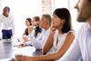 people watching a presentation in a meeting room